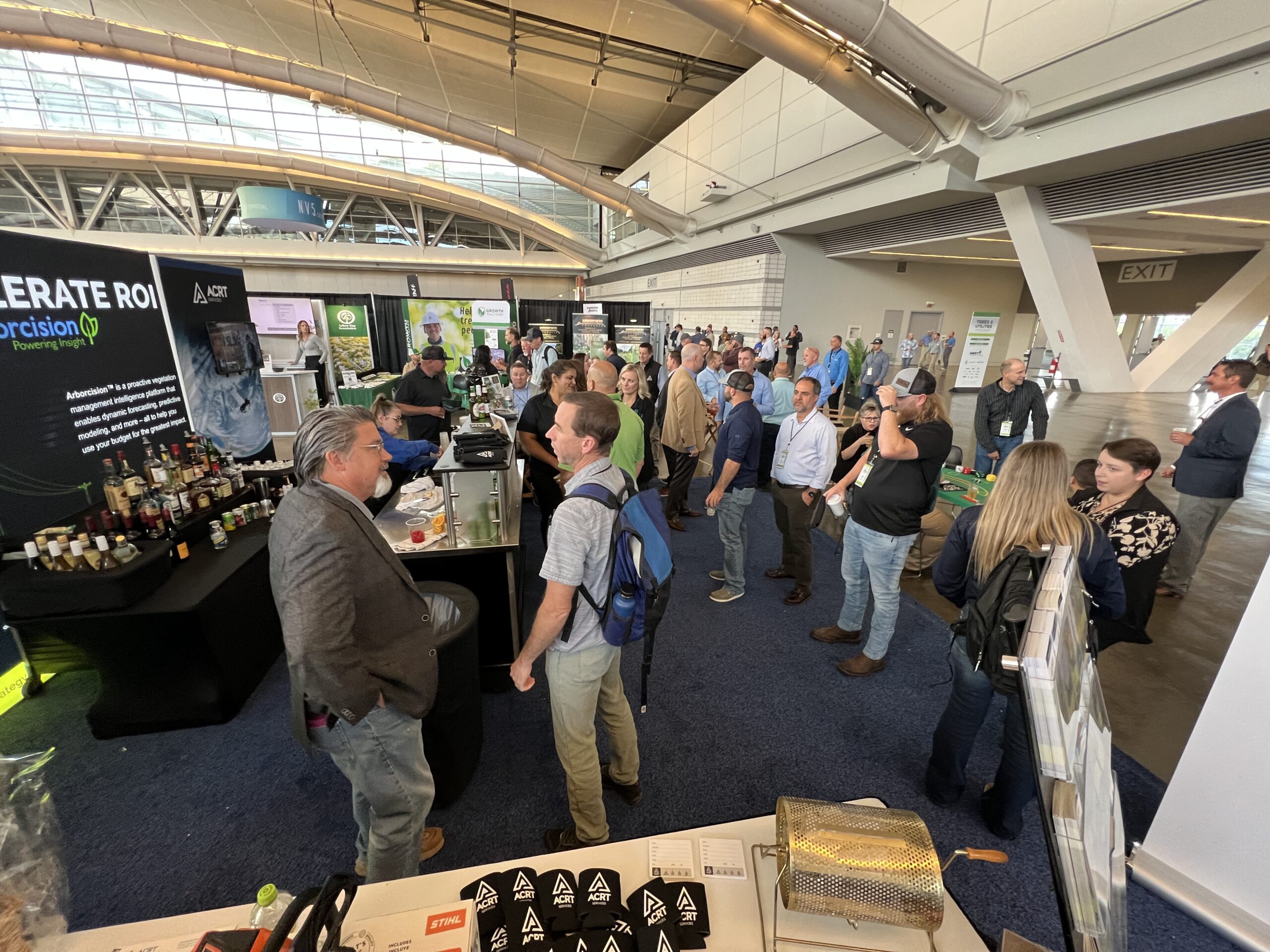 Attendees network in line at the ACRT booth during a trade show.